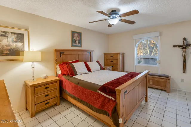 a living room with furniture a flat screen tv and a floor to ceiling window