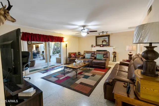 a view of a patio with table and chairs potted plants