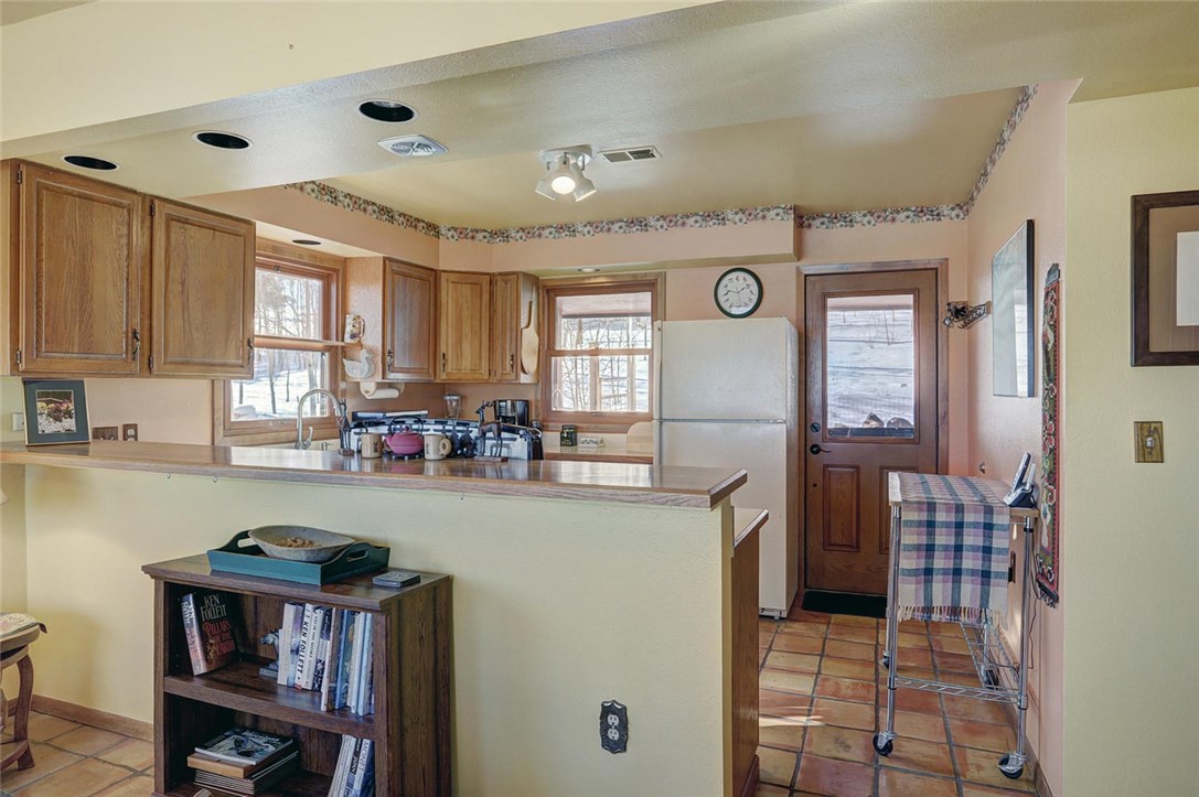 4283 Buffalo Ridge Road Como, CO 80432 - Photo 8 of 35 Kitchen has plenty of cabinets for storage and windows to let the light in.