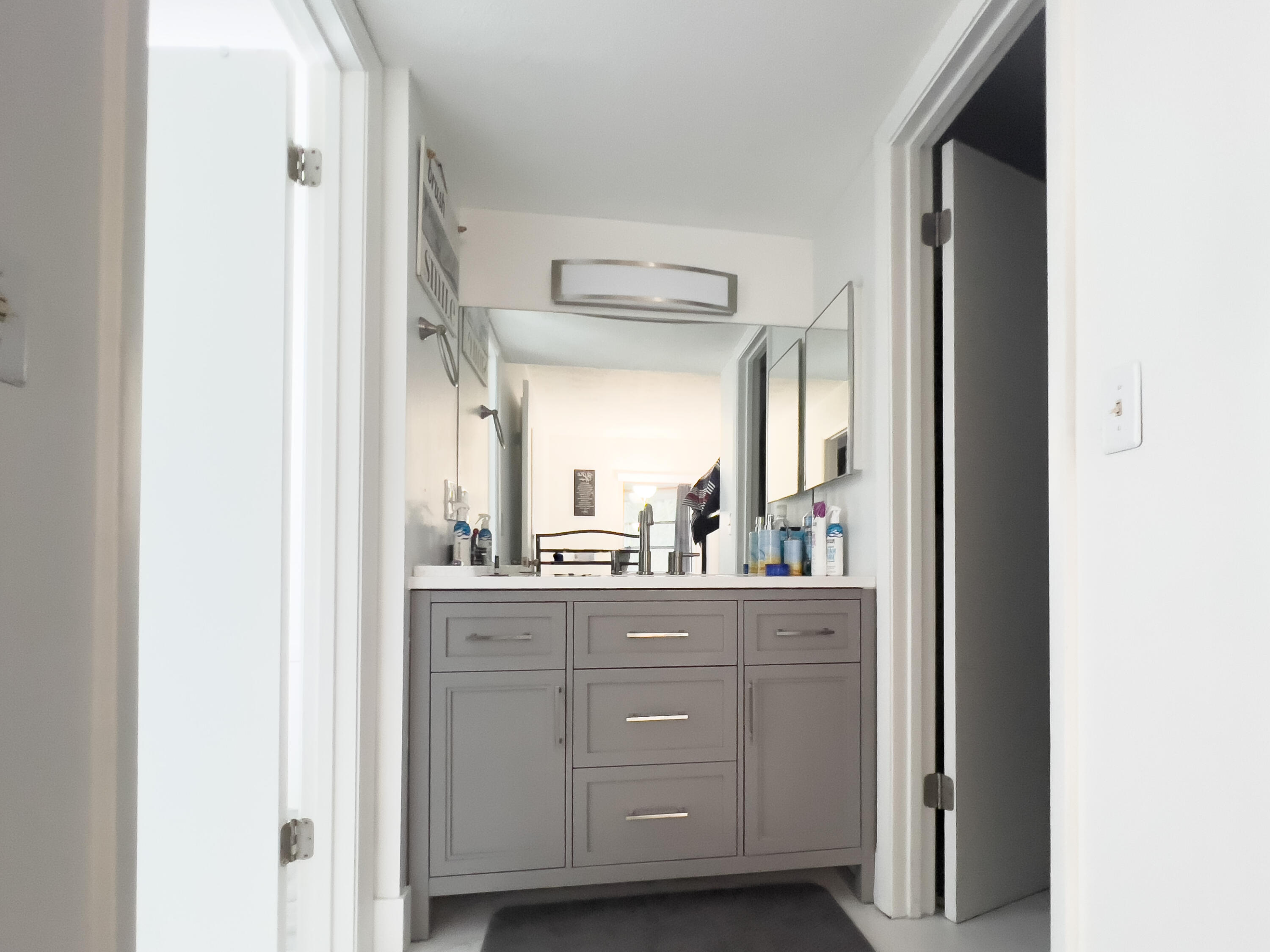 3278 Southeast Aster Lane, Unit 255 Stuart, FL 34994 - Photo 3 of 12 a bathroom with a granite countertop sink mirror and cabinets
