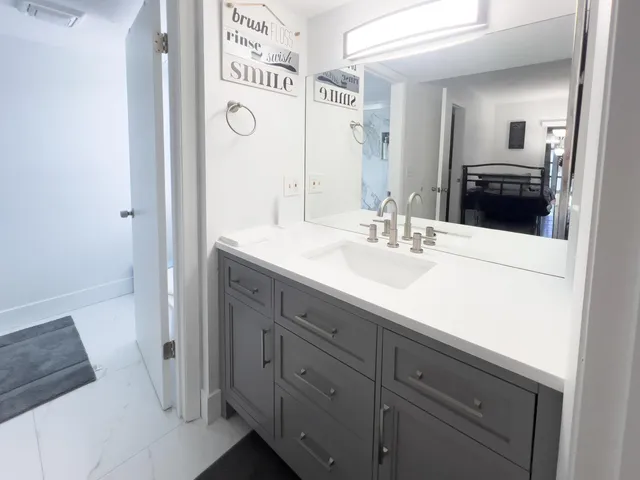 a bathroom with a sink vanity and a mirror