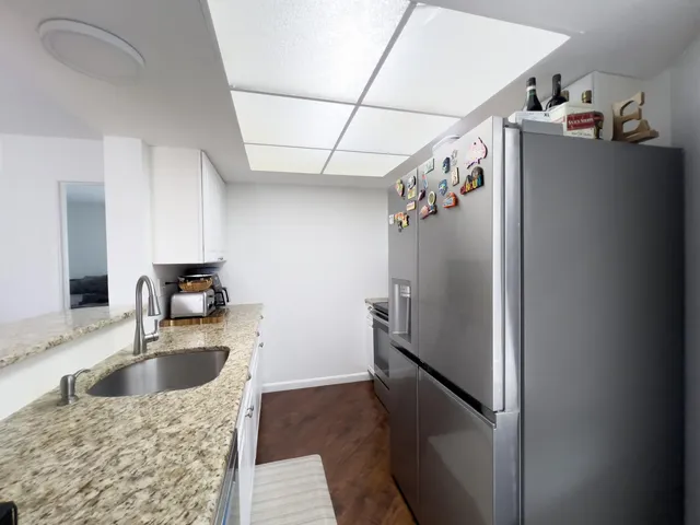 a kitchen with refrigerator a sink and dishwasher