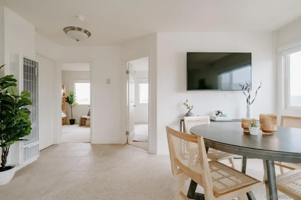 a dining room with furniture and wooden floor
