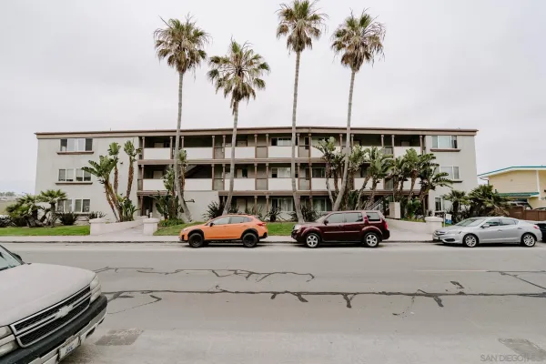 an outdoor view of a cars park in front of house