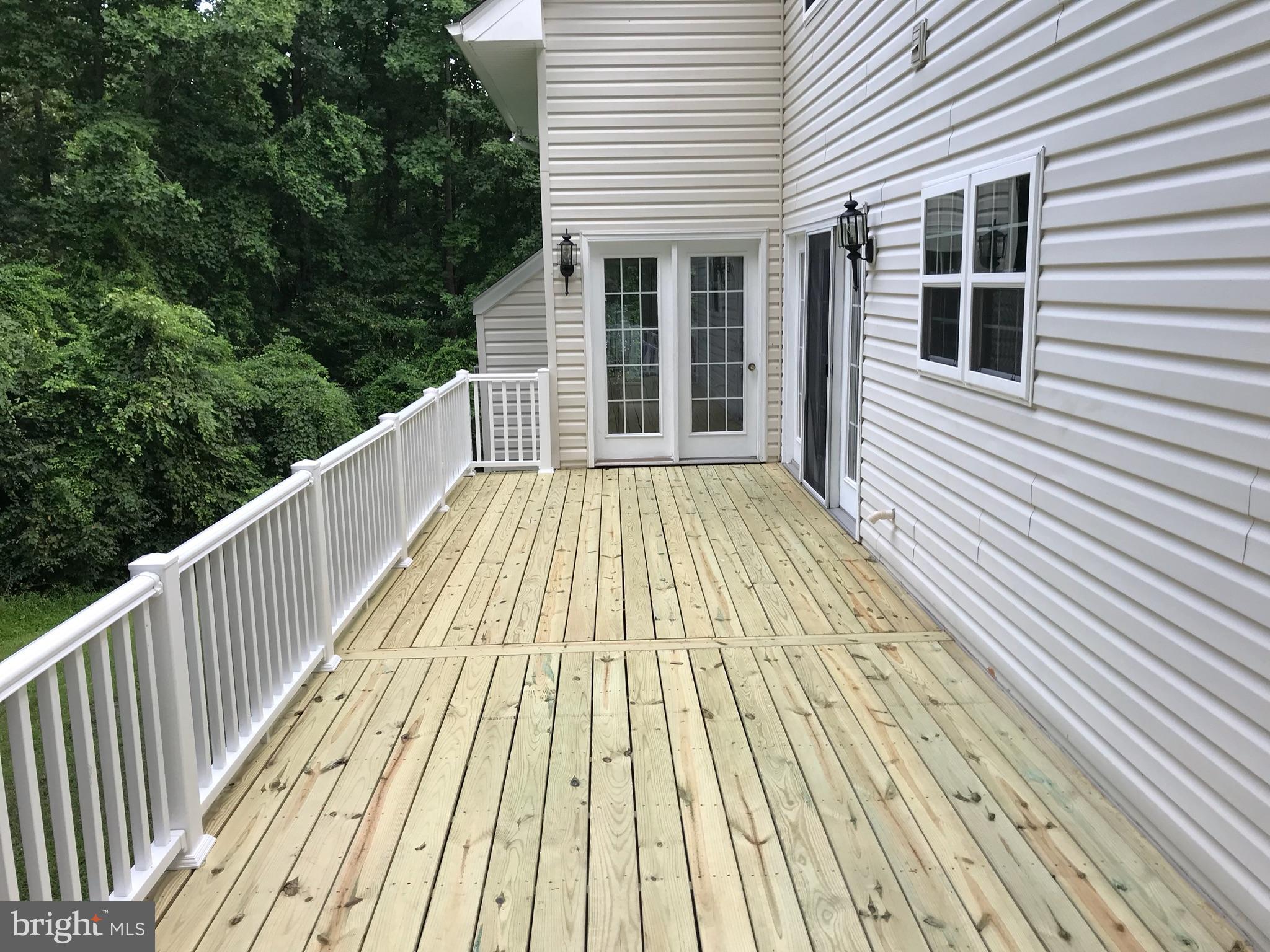 4613 Green Ridge Court Huntingtown, MD 20639 - Photo 28 of 29 New deck with access to kitchen and family room