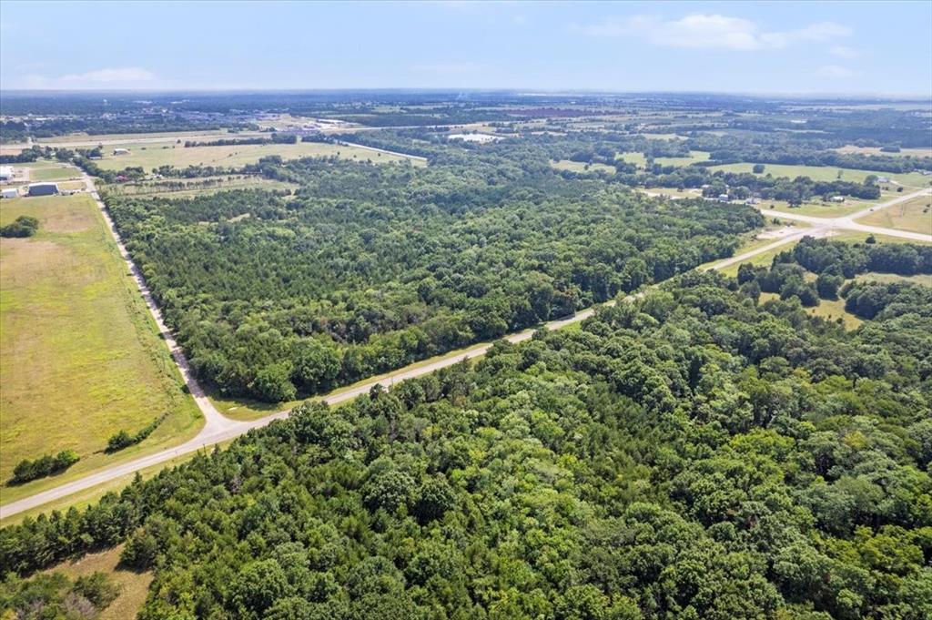 0 Tx-121 & Airport Road Bonham, TX 75418 - Photo 15 of 18 an aerial view of residential houses with outdoor space and trees