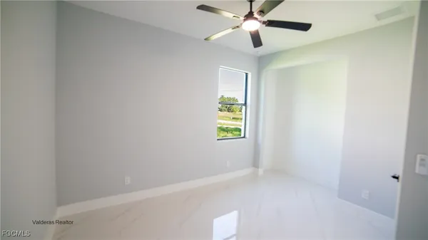 a view of an empty room with a window