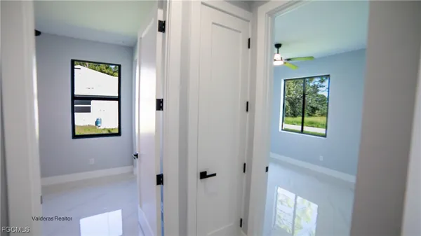 a bathroom with a window and a shower