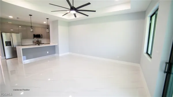 a large kitchen with a refrigerator a stove top oven a sink and dishwasher