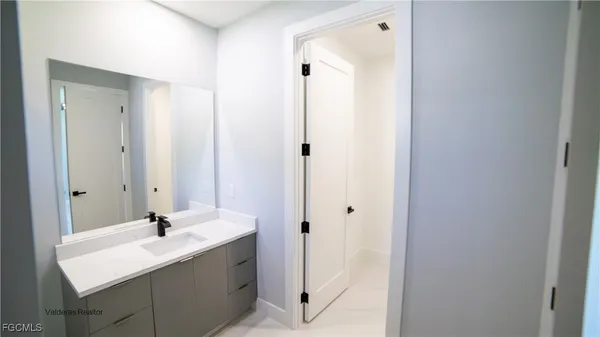 a bathroom with a sink and a mirror