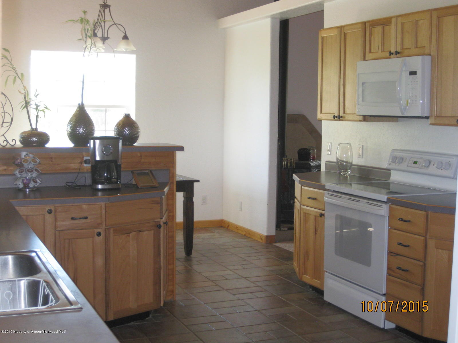 200 Fox Run Road Rifle, CO 81650 - Photo 6 of 21 a kitchen with stainless steel appliances granite countertop a sink stove and cabinets