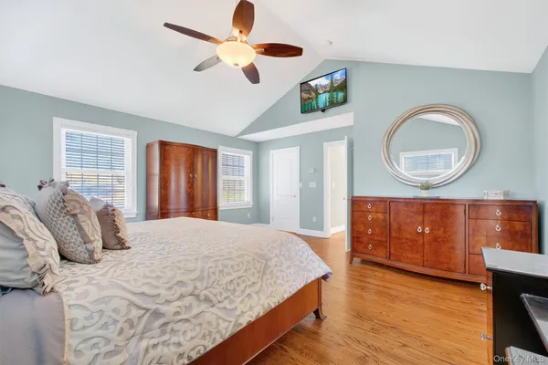 a bedroom with a bed dresser and a window