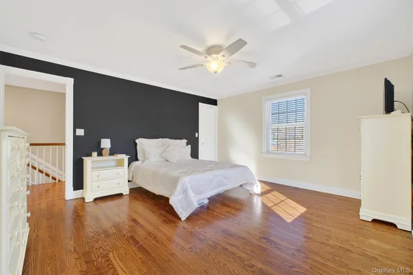 a spacious bedroom with a bed and a window