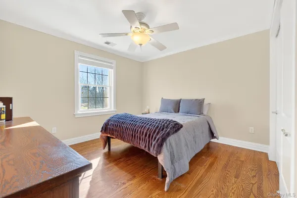 a spacious bedroom with a bed and a cabinets