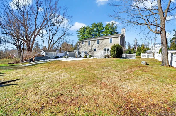 a view of a house with a yard and garage