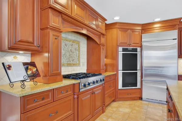 a kitchen with stainless steel appliances granite countertop a stove and a refrigerator