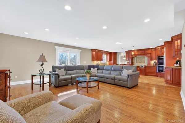 a living room with furniture and view of kitchen