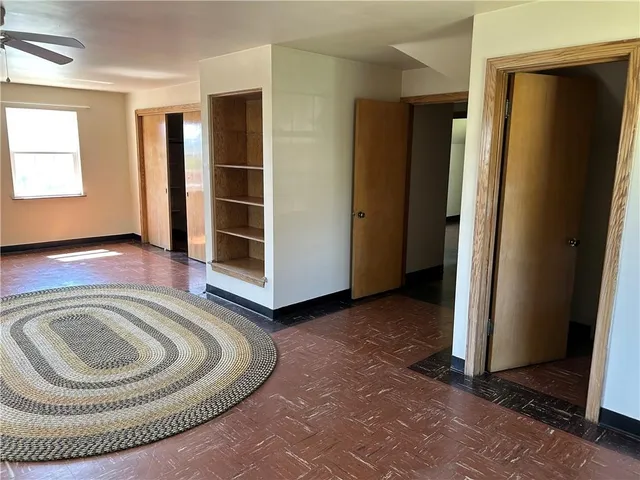a view of a livingroom with furniture and an empty room