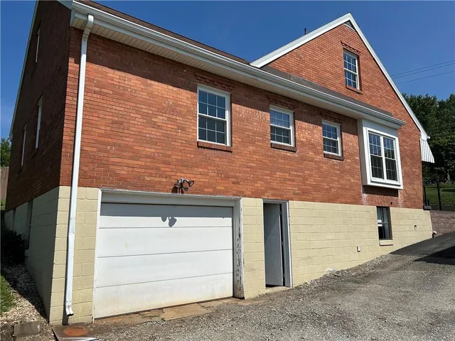 a front view of a house with garage