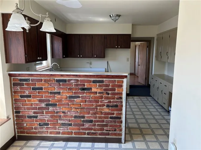 a view of a kitchen with cabinets and outdoor space