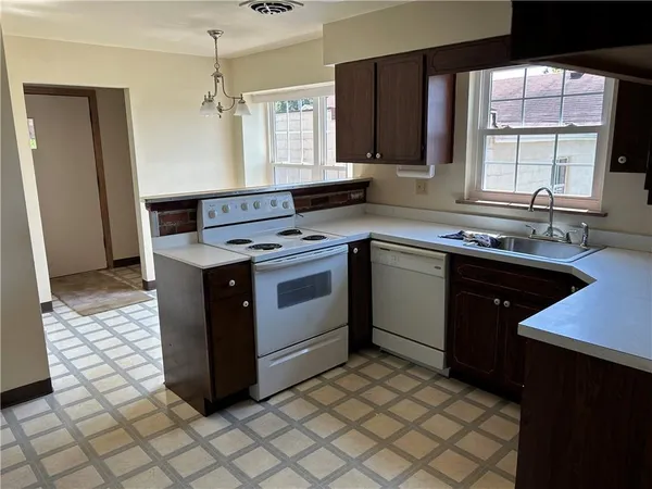a kitchen with a sink stove and cabinets