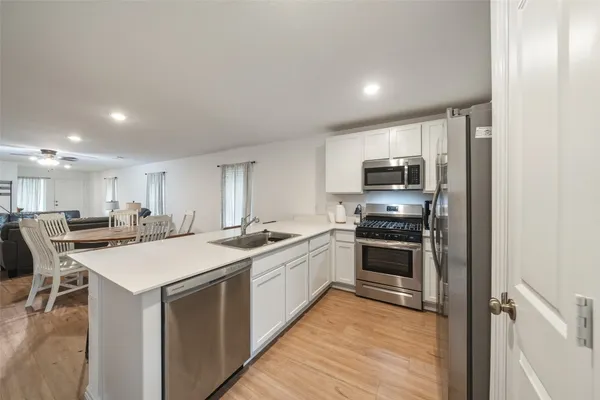 a view of a dining room with furniture and wooden floor