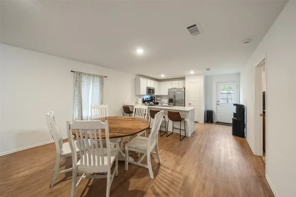 a view of a dining room with furniture and wooden floor