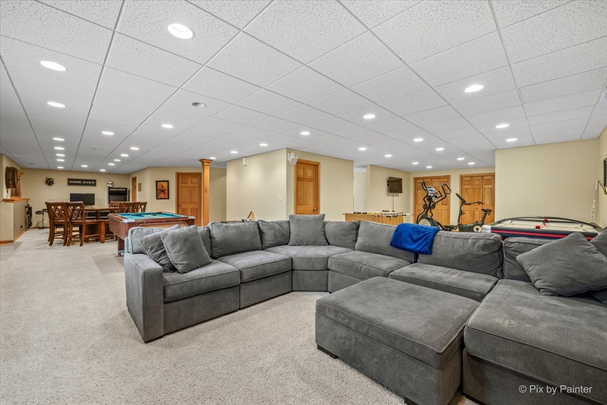 7104 Dove Way Cary, IL 60013 - Photo 50 of 82 a living room with furniture kitchen view and a chandelier