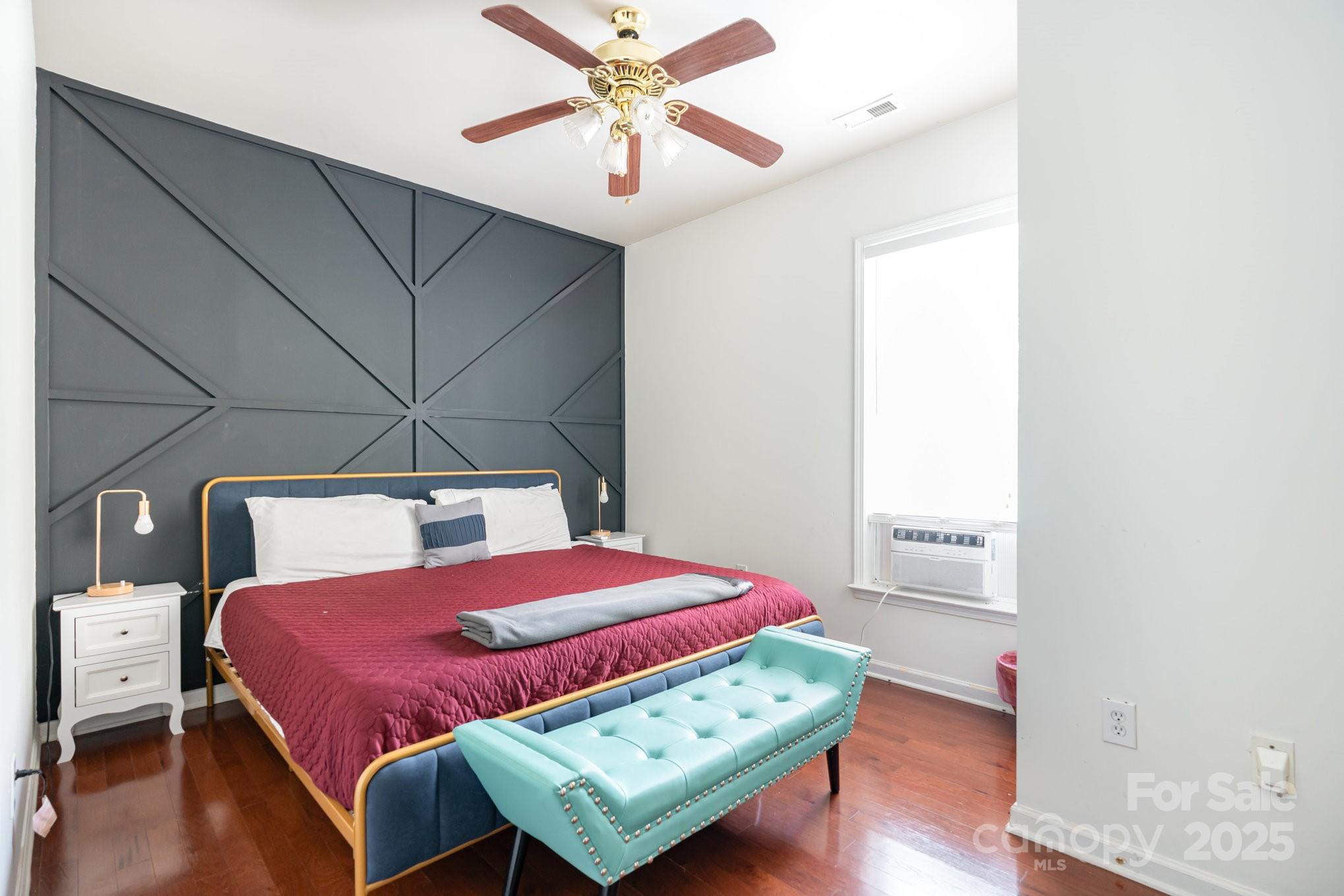 306 Nance Road Charlotte, NC 28214 - Photo 16 of 40 a bedroom with a bed a dresser and wooden floor