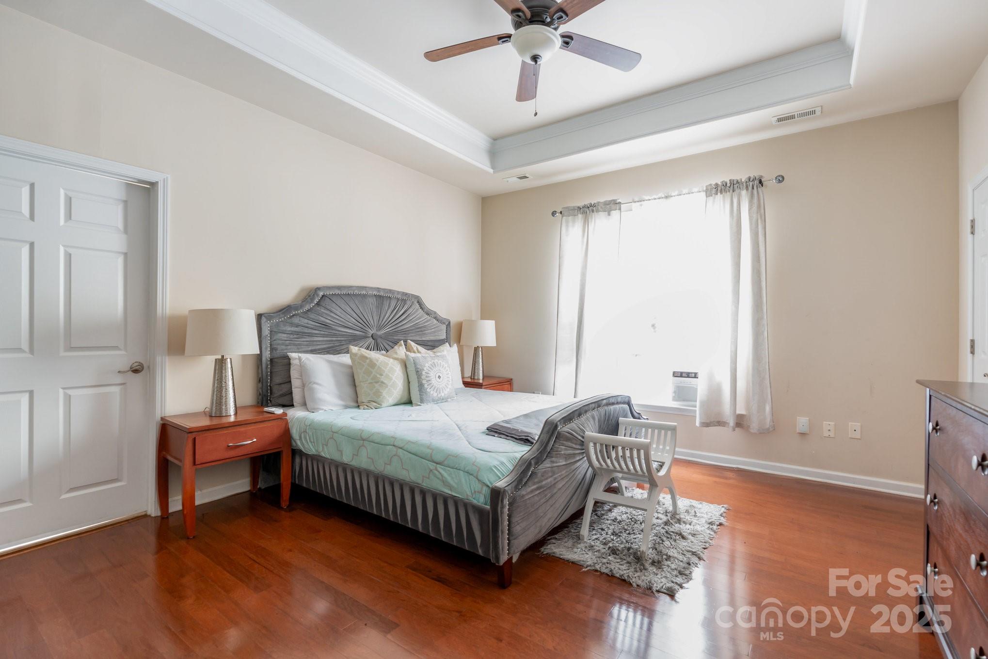 306 Nance Road Charlotte, NC 28214 - Photo 18 of 40 a bedroom with a bed and a chandelier