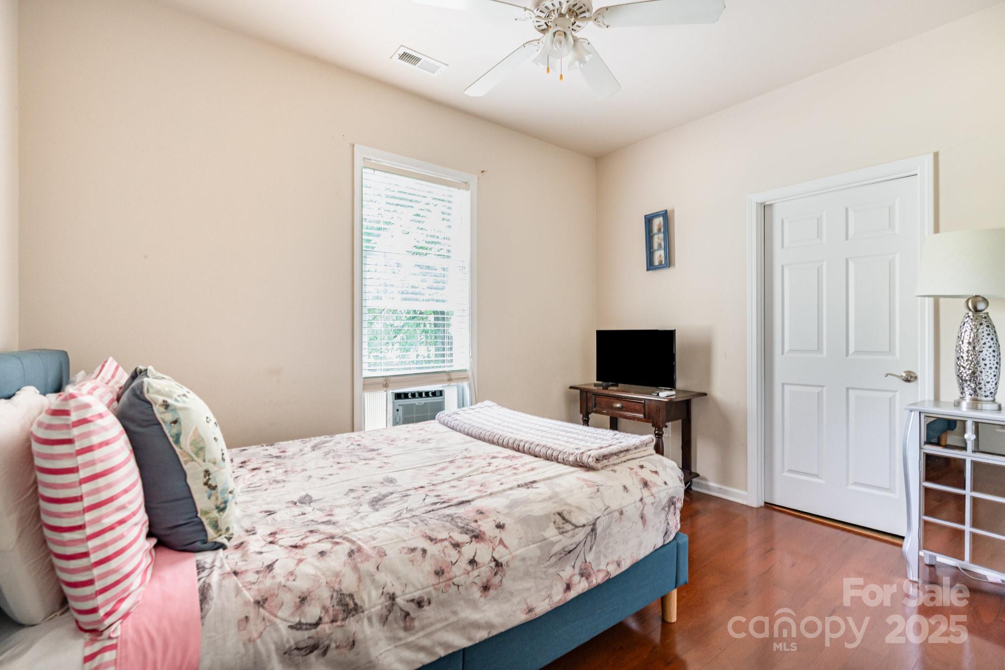 306 Nance Road Charlotte, NC 28214 - Photo 21 of 40 a bedroom with a bed and a chandelier