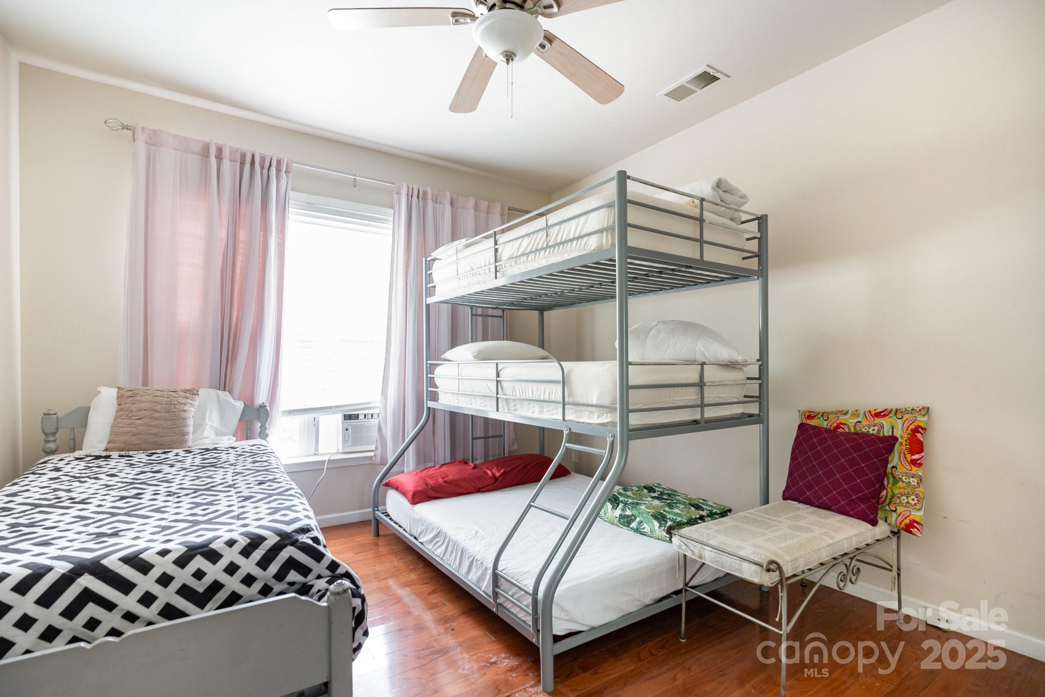 306 Nance Road Charlotte, NC 28214 - Photo 26 of 40 a bedroom with a bed and ceiling fan