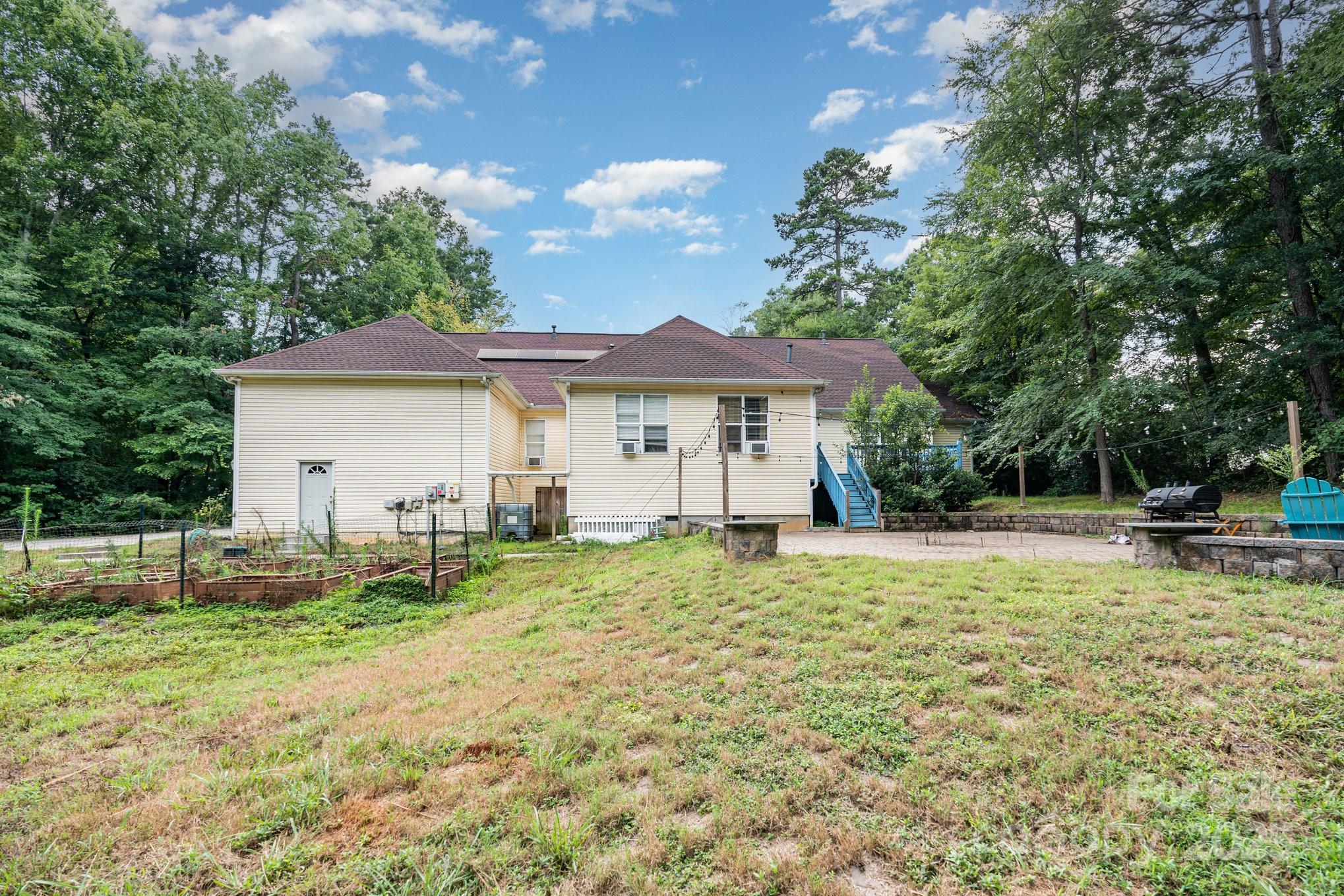 306 Nance Road Charlotte, NC 28214 - Photo 37 of 40 a house with lots of trees in the background
