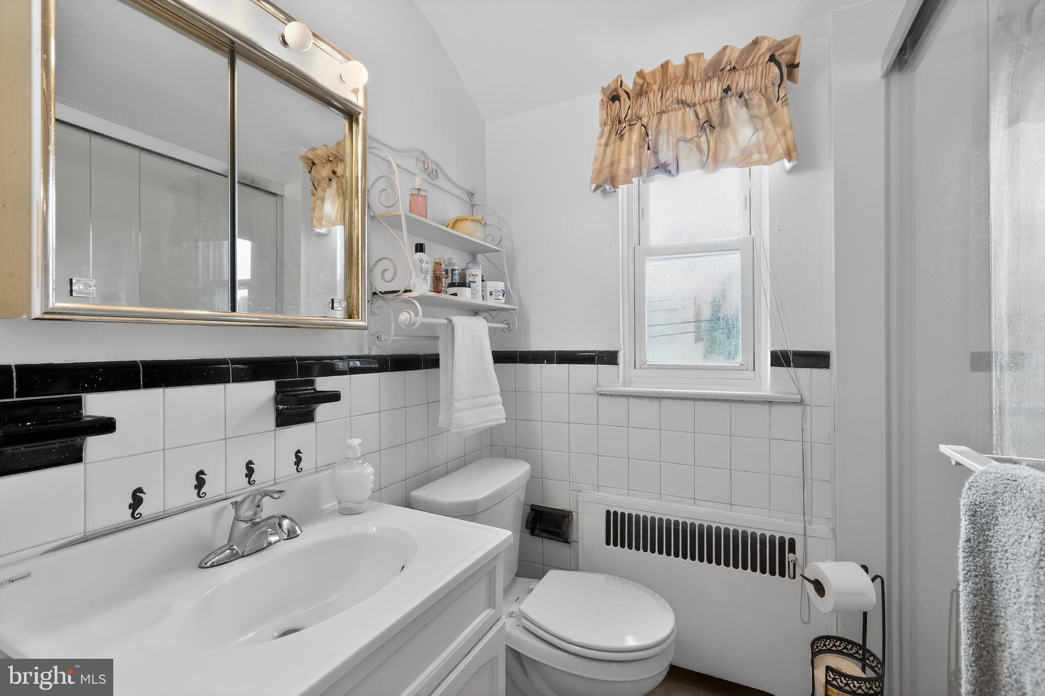 1424 Burmont Road Havertown, PA 19083 - Photo 26 of 37 a bathroom with a sink a toilet and shower