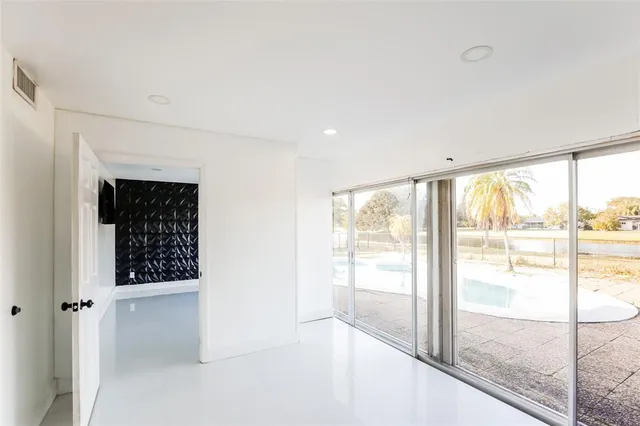 a view of a room with wooden floor and windows