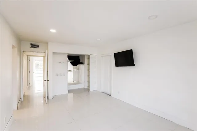 a large kitchen with a sink and dishwasher a stove top oven with wooden floor