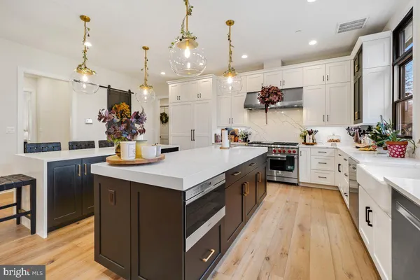 a kitchen with stainless steel appliances a refrigerator and cabinets