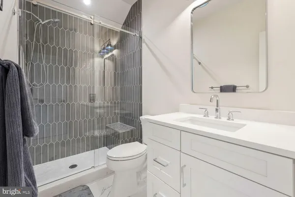 a view of a big yard in front of a brick house with a big yard and large trees