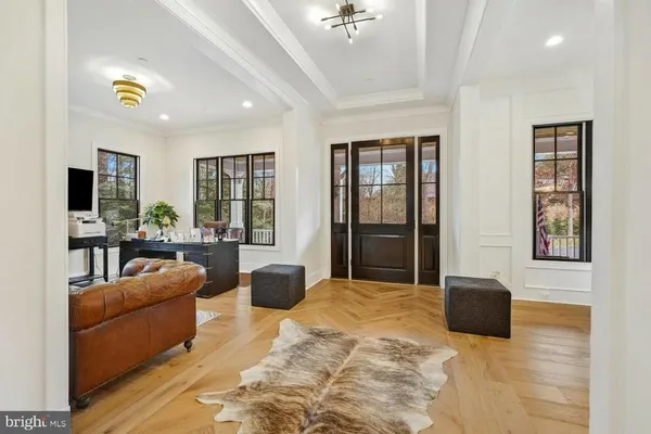 a living room with furniture a flat screen tv and a large window