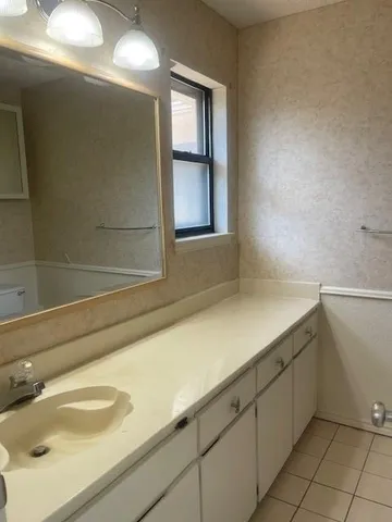 a bathroom with a sink and a window
