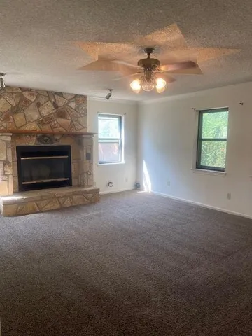 a view of empty room with window and fireplace