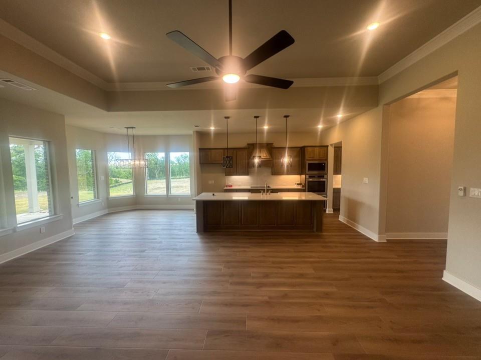 412 Indian Crk Road Van Alstyne, TX 75495 - Photo 8 of 24 a view of a big room with wooden floor and windows
