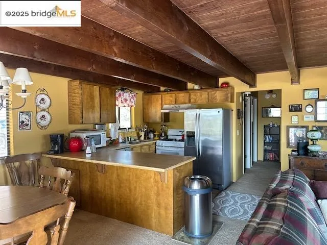 a kitchen with stainless steel appliances granite countertop a sink window and refrigerator