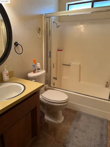 a bathroom with a sink a toilet and a mirror