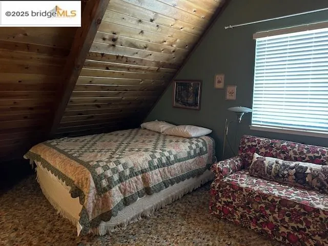 a bedroom with bed and window