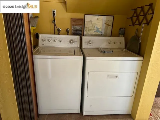 a view of washer and dryer with wooden door