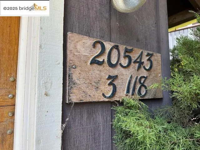 a street sign that is on a wooden wall