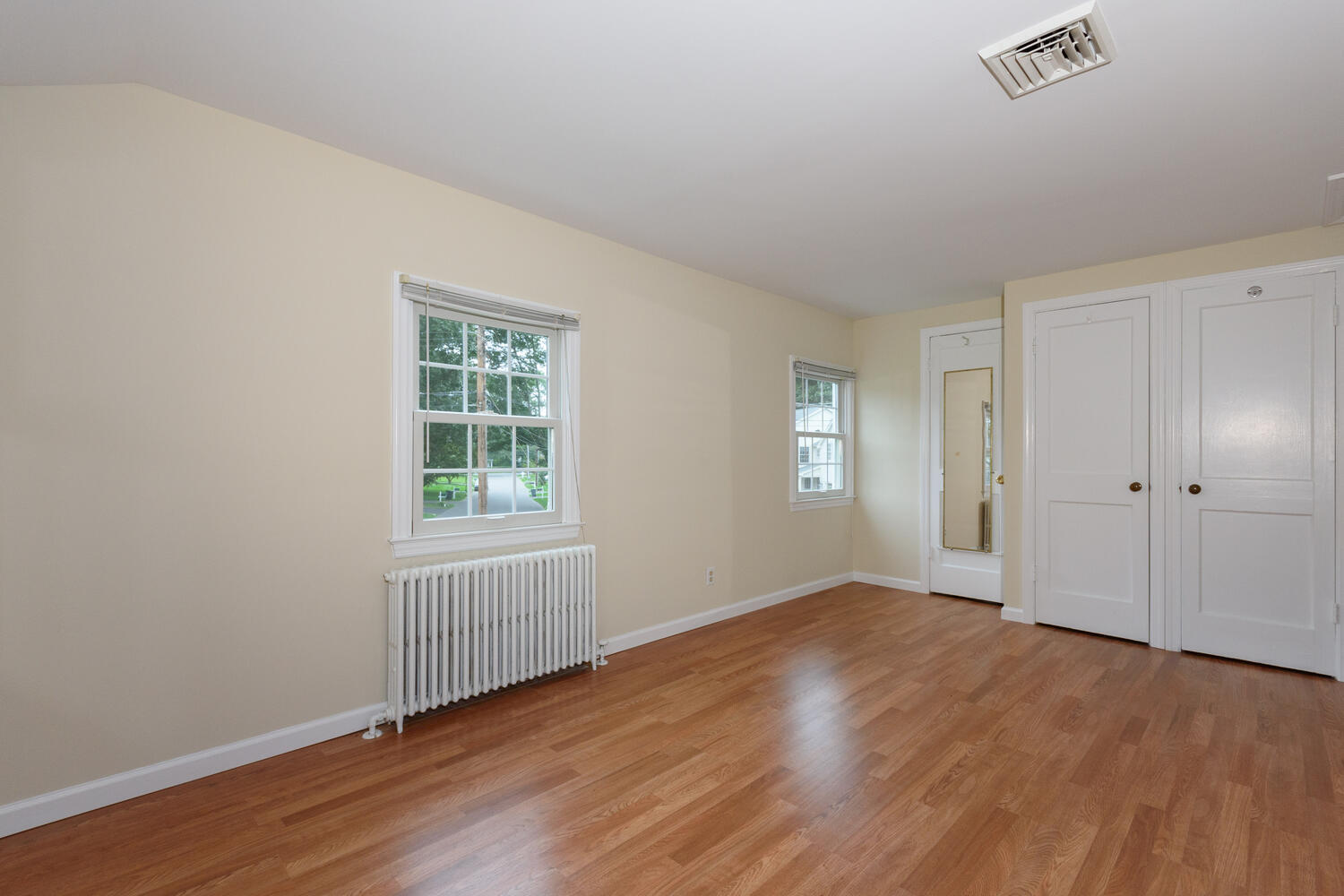 15 Miles Road Darien, CT 06820 - Photo 12 of 23 an empty room with wooden floor and windows