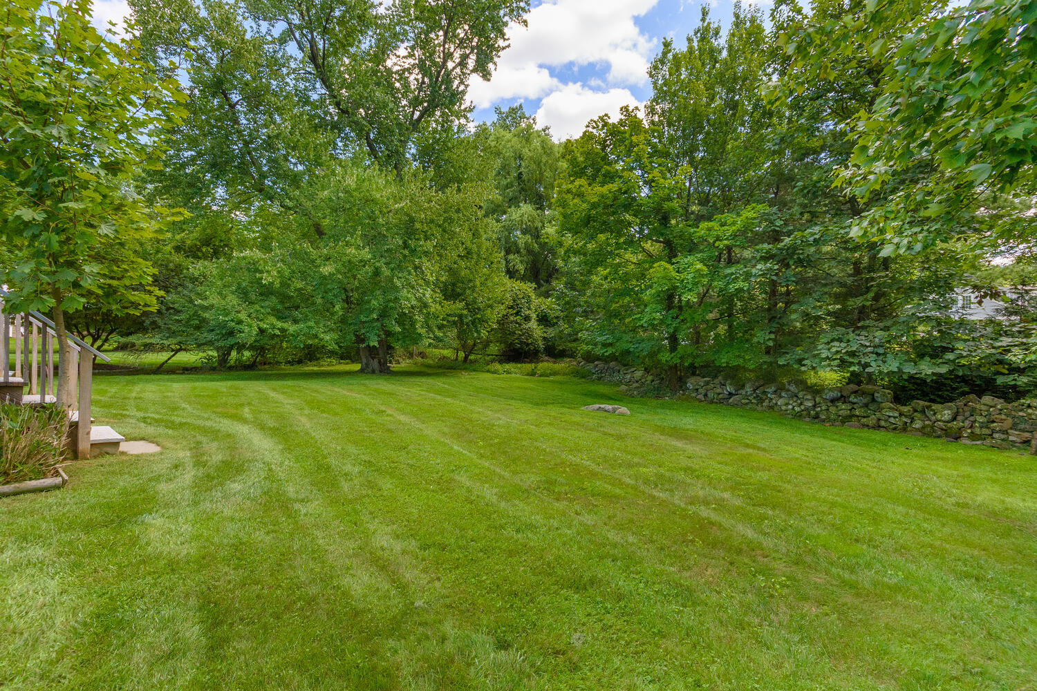 15 Miles Road Darien, CT 06820 - Photo 19 of 23 a view of a grassy field with trees