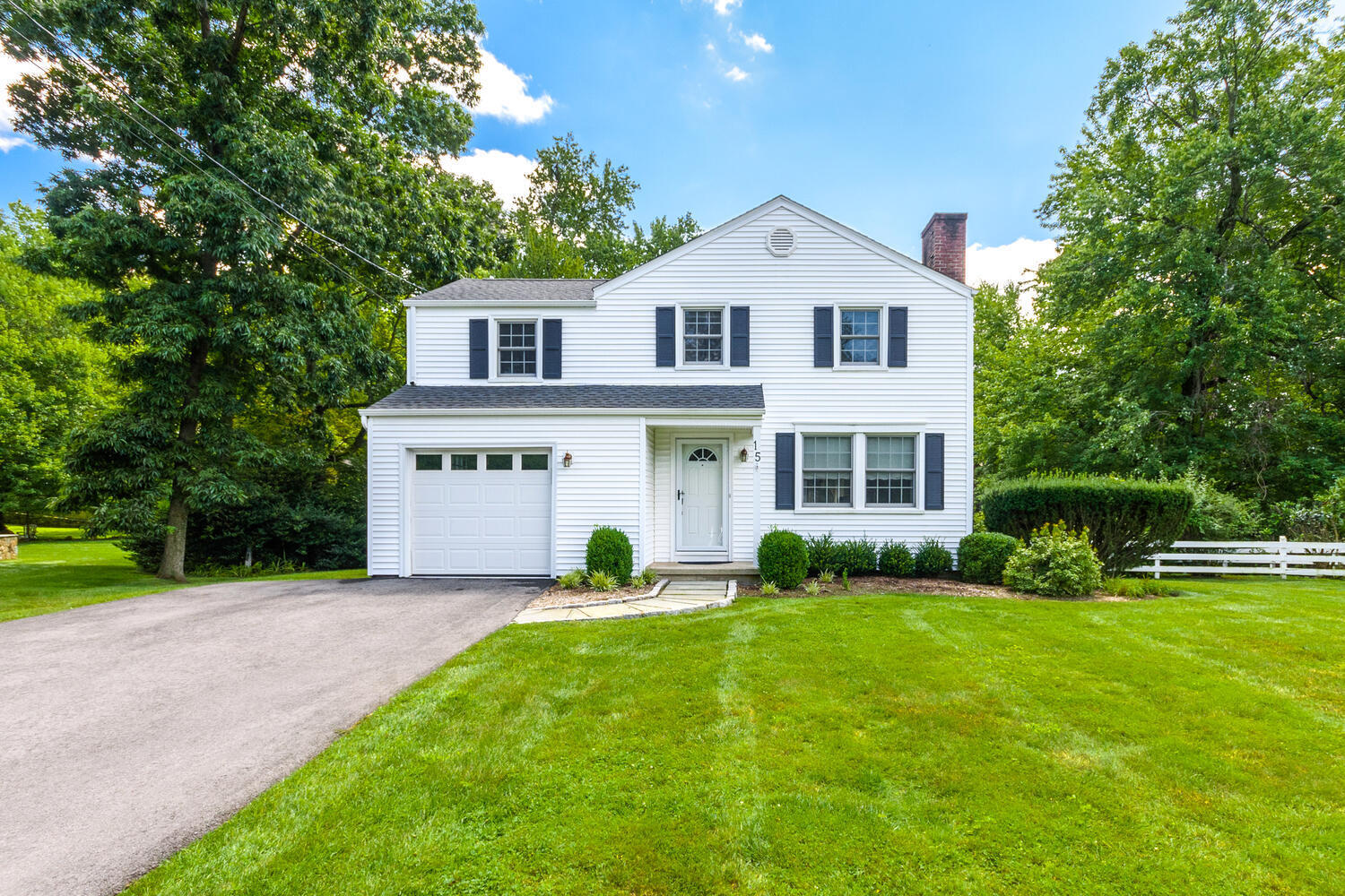 15 Miles Road Darien, CT 06820 - Photo 2 of 23 a front view of a house with a yard and trees